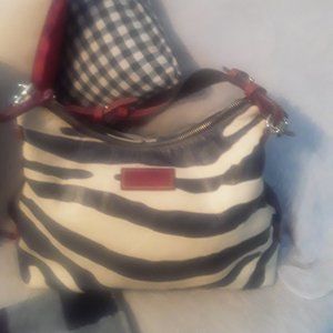 Authentic Dooney and Bourke zebra print purse with red detailing.
